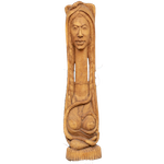 A tall Hatian carved wood sculpture guards the door,